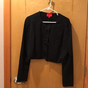 Black cropped jacket with snap closures.
